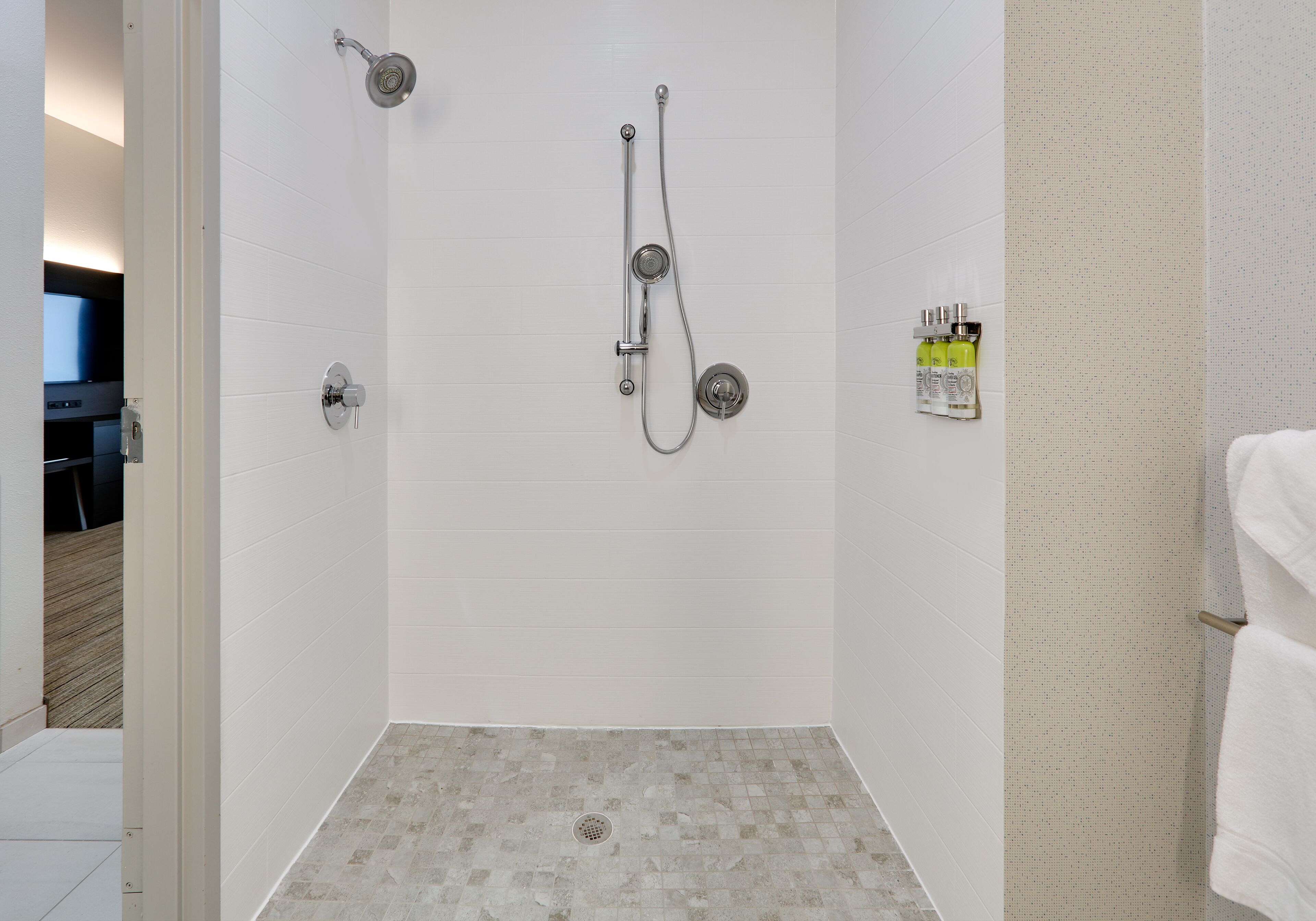 suite, 1 king bed, roll-in shower (communications, roll-in shower) | bathroom | shower, hair dryer, towels