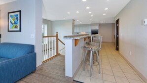 A modern apartment with a living room, kitchen, and a staircase. - Holiday Inn Express & Suites Petoskey by IHG (Petoskey)