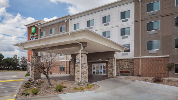 A Holiday Inn Express building with a covered entrance, stone pillars, and a brick facade. - Holiday Inn Express Hastings by IHG (Hastings)