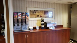 A self-serve breakfast station with Kellogg's cereals, a coffee machine, and a self-serve pancake maker. - Microtel Inn & Suites by Wyndham Dover (Dover)