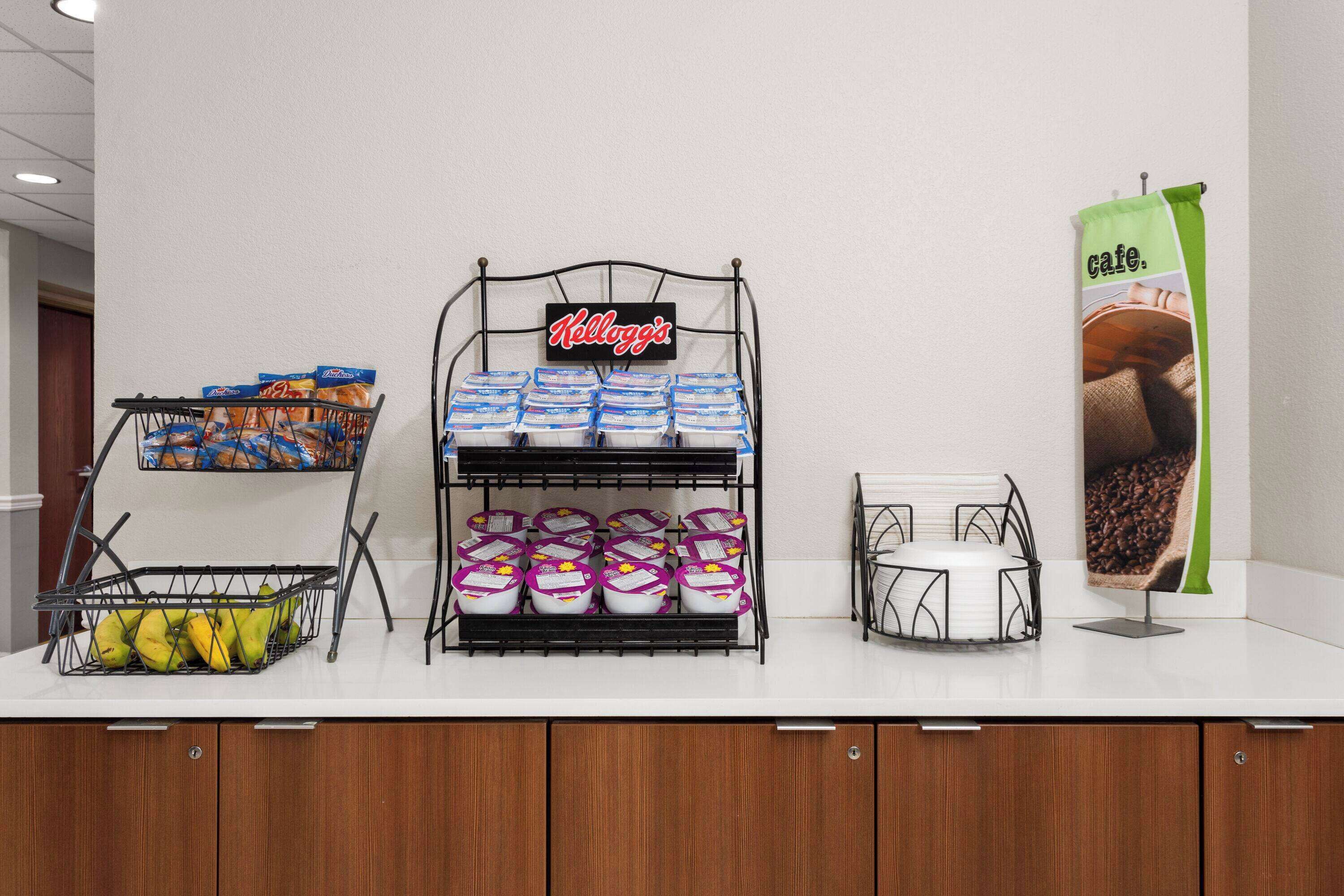 A counter with a display of packaged goods, including a sign for 'Kellogg's' and a coffee bag.