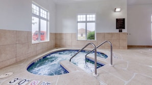 A spa area with a hot tub, tiled walls, and windows. - Comfort Inn Plover-Stevens Point (Plover)