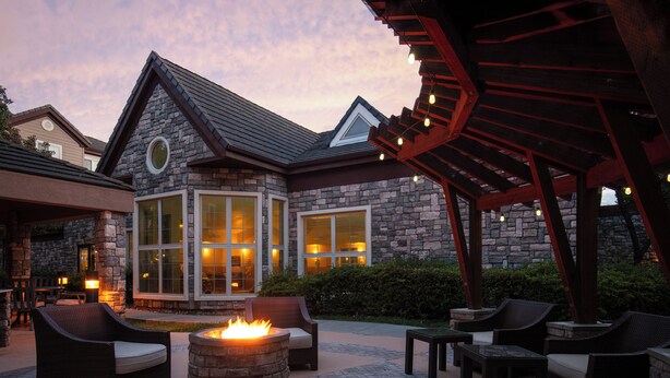A stone building with a fire pit and outdoor seating. - Staybridge Suites Fairfield Napa Valley Area by IHG (Fairfield)
