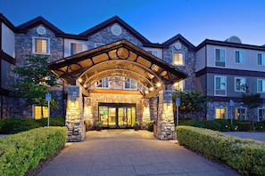 A hotel entrance with a stone facade, a covered walkway, and a parking sign indicating 'PARKING ONLY'. - Staybridge Suites Fairfield Napa Valley Area by IHG (Fairfield)