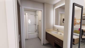 A modern bathroom with a bathtub, a sink, and a mirror.