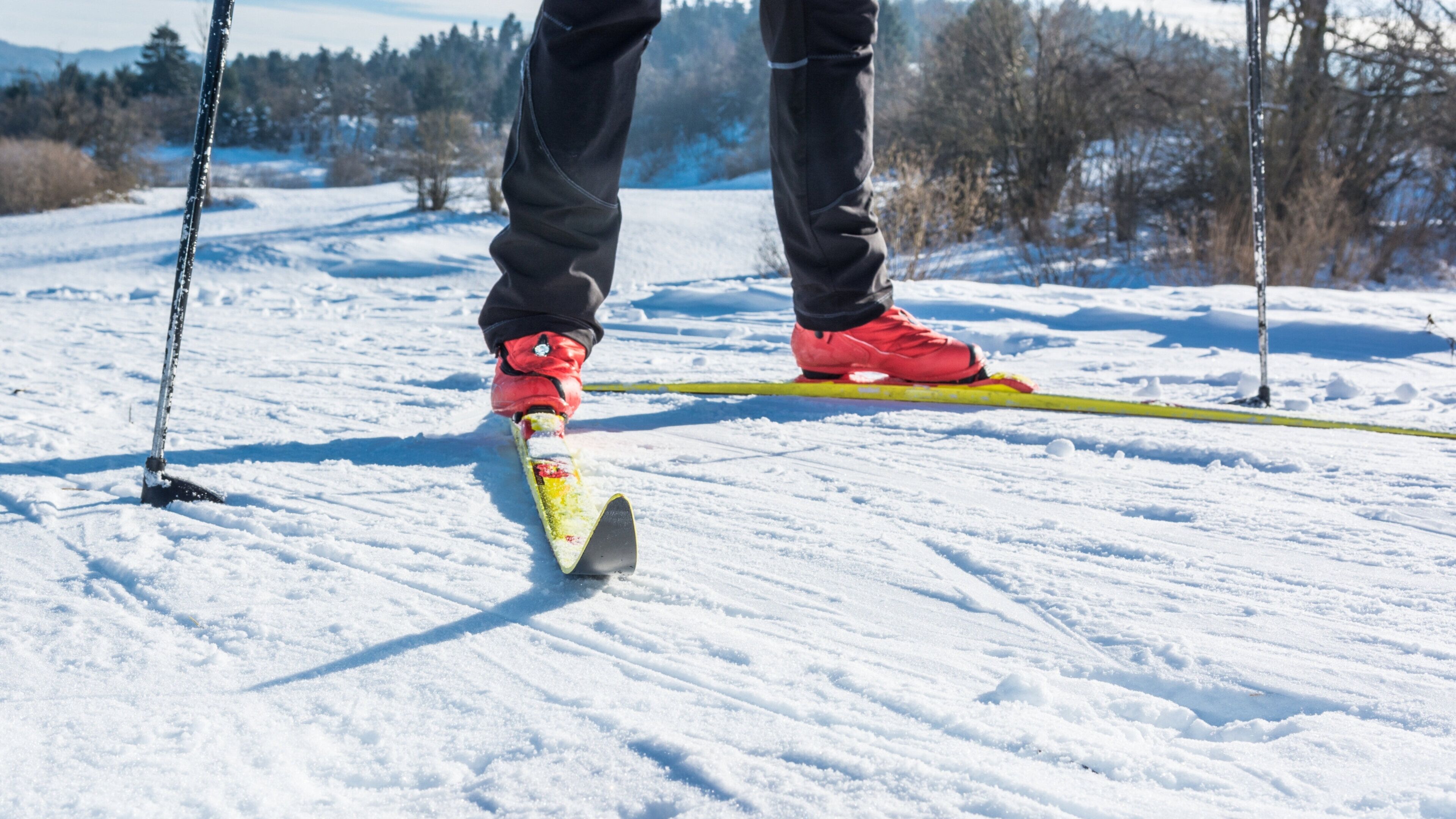 A snowy landscape with a person skiing.