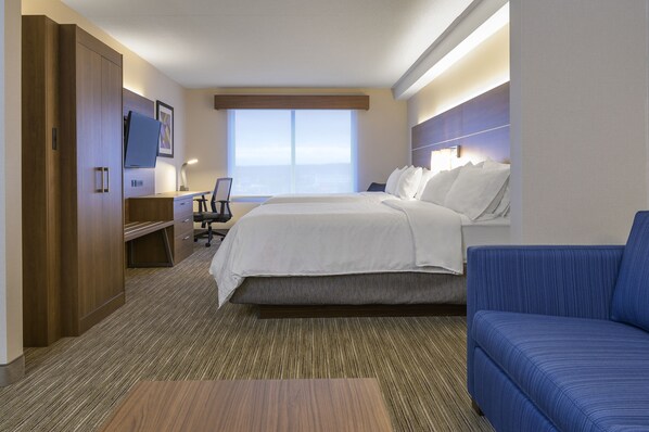 A hotel room with a bed, a desk, a chair, a TV, and a sofa. - Holiday Inn Express & Suites North Bay by IHG (North Bay)