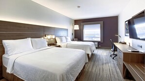 A hotel room with two beds, a desk, a TV, and a window with a view. - Holiday Inn Express Airport-Calgary by IHG (Calgary)
