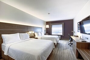 A hotel room with two beds, a desk, a TV, and a window with a view. - Holiday Inn Express Airport-Calgary by IHG (Calgary)
