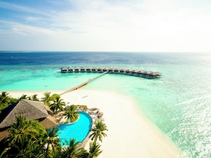 An overwater bungalows connected by a pier, a swimming pool, and a beach. - Filitheyo Island Resort (Filitheyo)