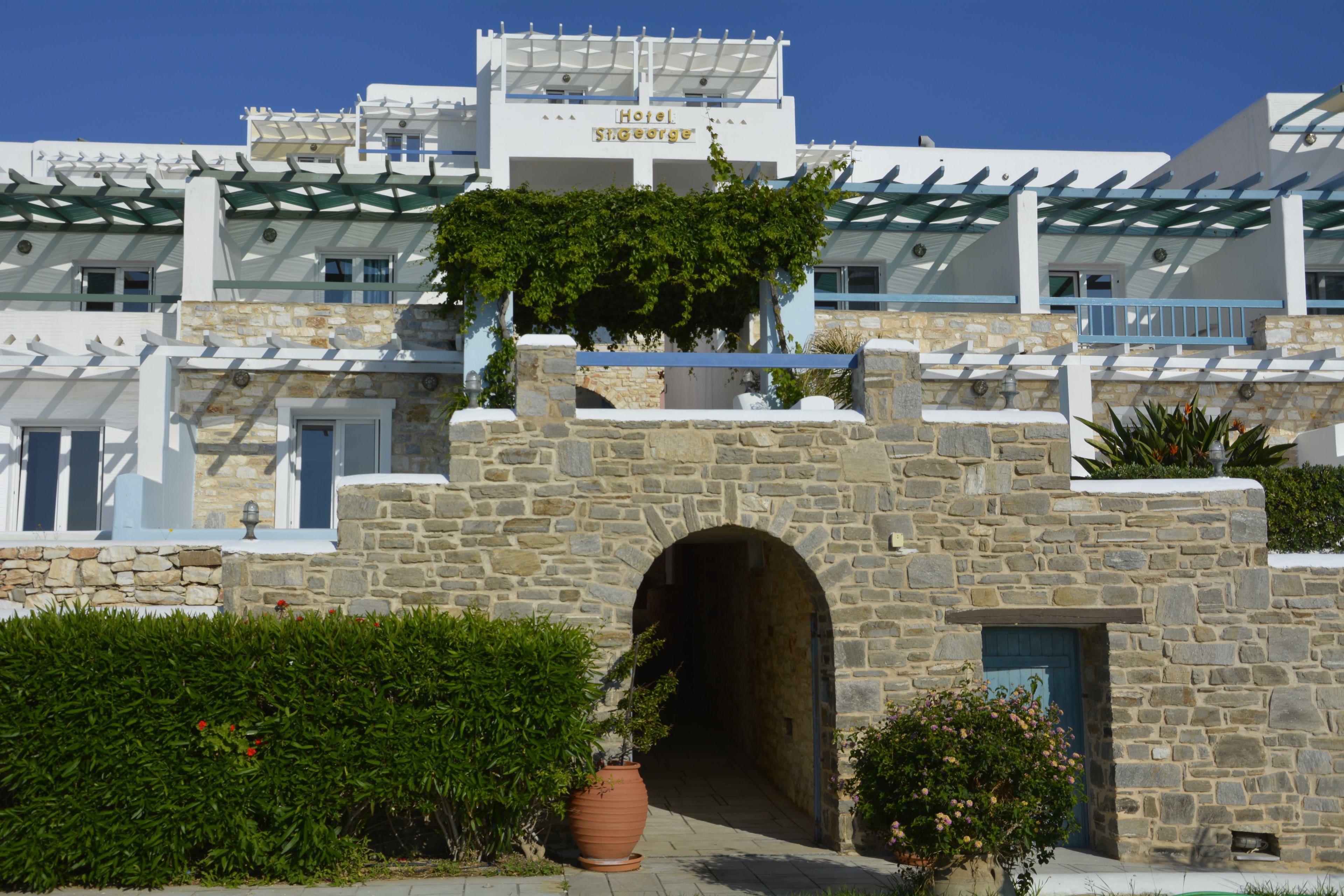 A hotel with a stone facade, a central archway, and a sign reading "Hotel St. George."