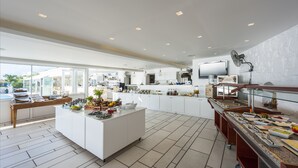 A modern kitchen with a central island, ample counter space, and a variety of appliances.