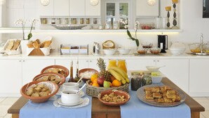 A breakfast buffet with various food items and drinks.