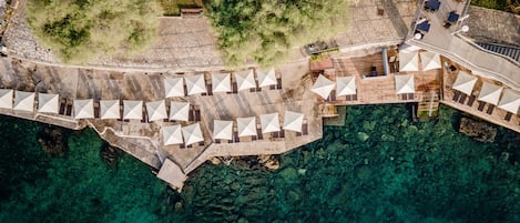 On the beach, white sand, sun-loungers, beach umbrellas