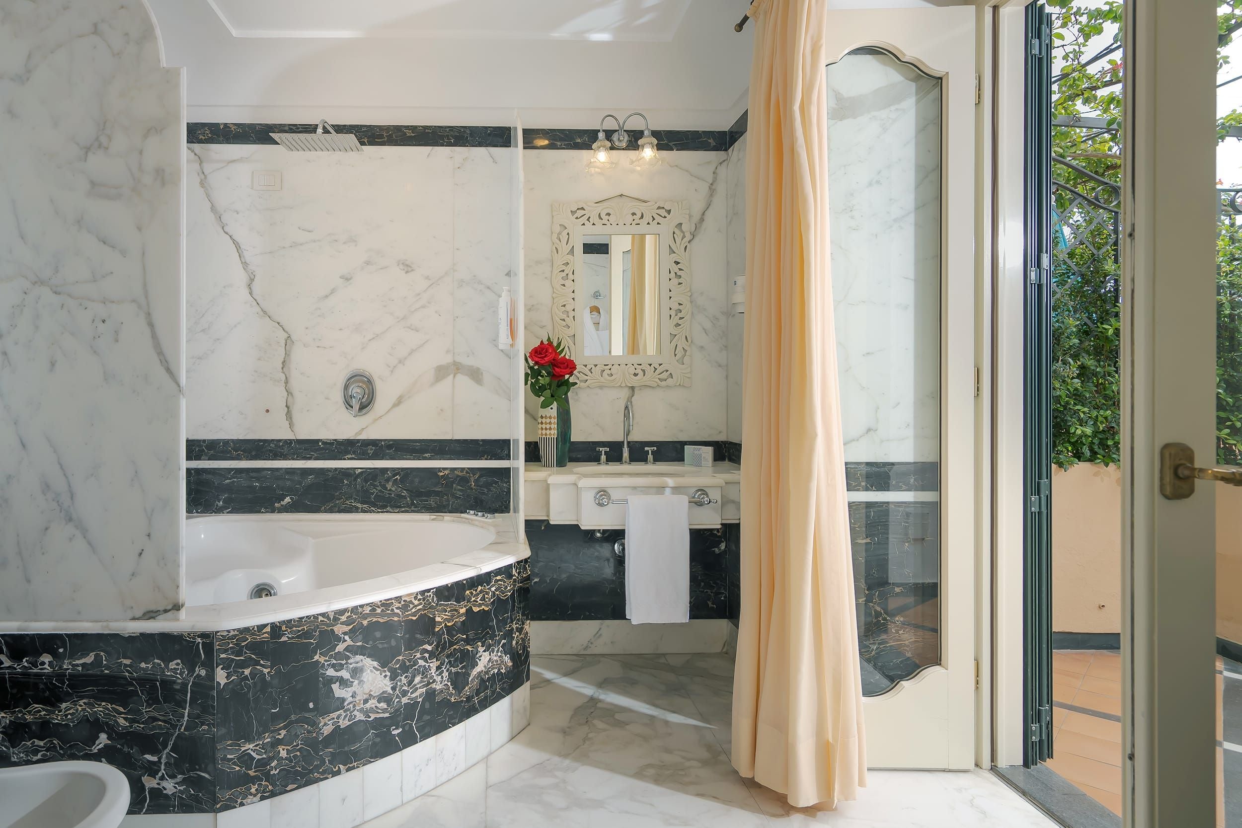 A bathroom with a bathtub, a shower, and a sink.