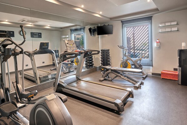 A gym with treadmills, ellipticals, and weight machines.