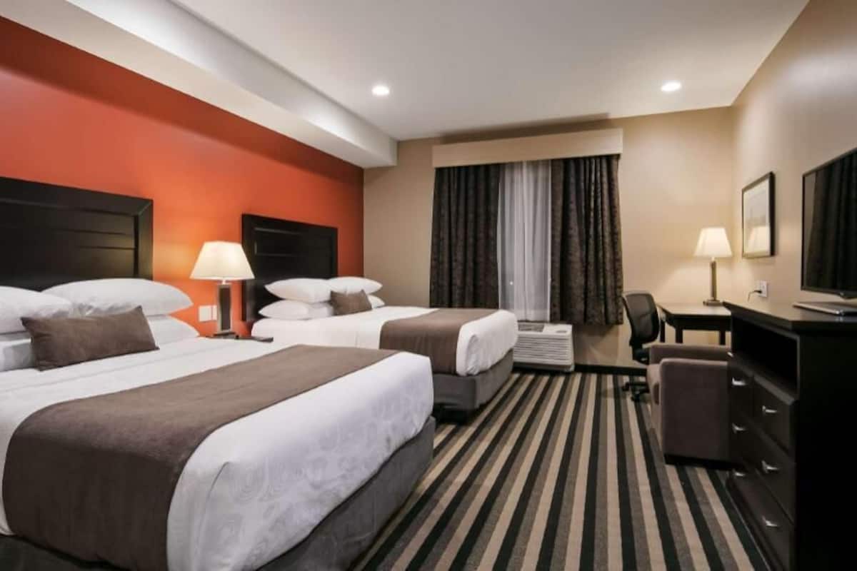 Premium bedding, pillow-top beds, desk, laptop workspace