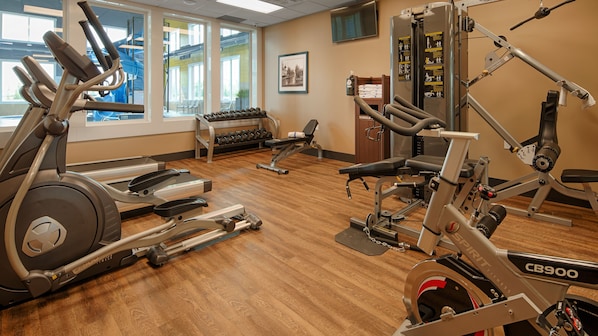 A gym with cardio machines, weightlifting equipment, and dumbbells. - Best Western Plus Meridian Hotel (Lloydminster)