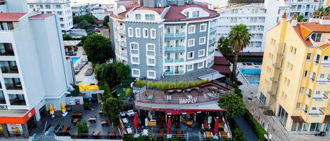 Un hotel con piscina sul tetto, area salotto all'aperto e vista mare.
