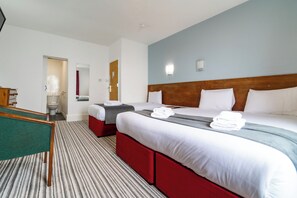 A hotel room with two beds, a desk, and a bathroom. - The Southcliff Hotel (Folkestone)