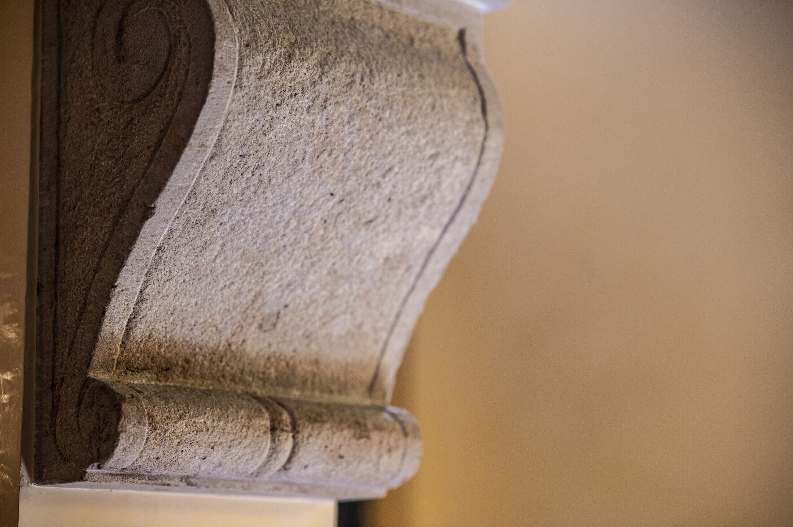 A close-up of a stone architectural detail, likely part of a building's structure.