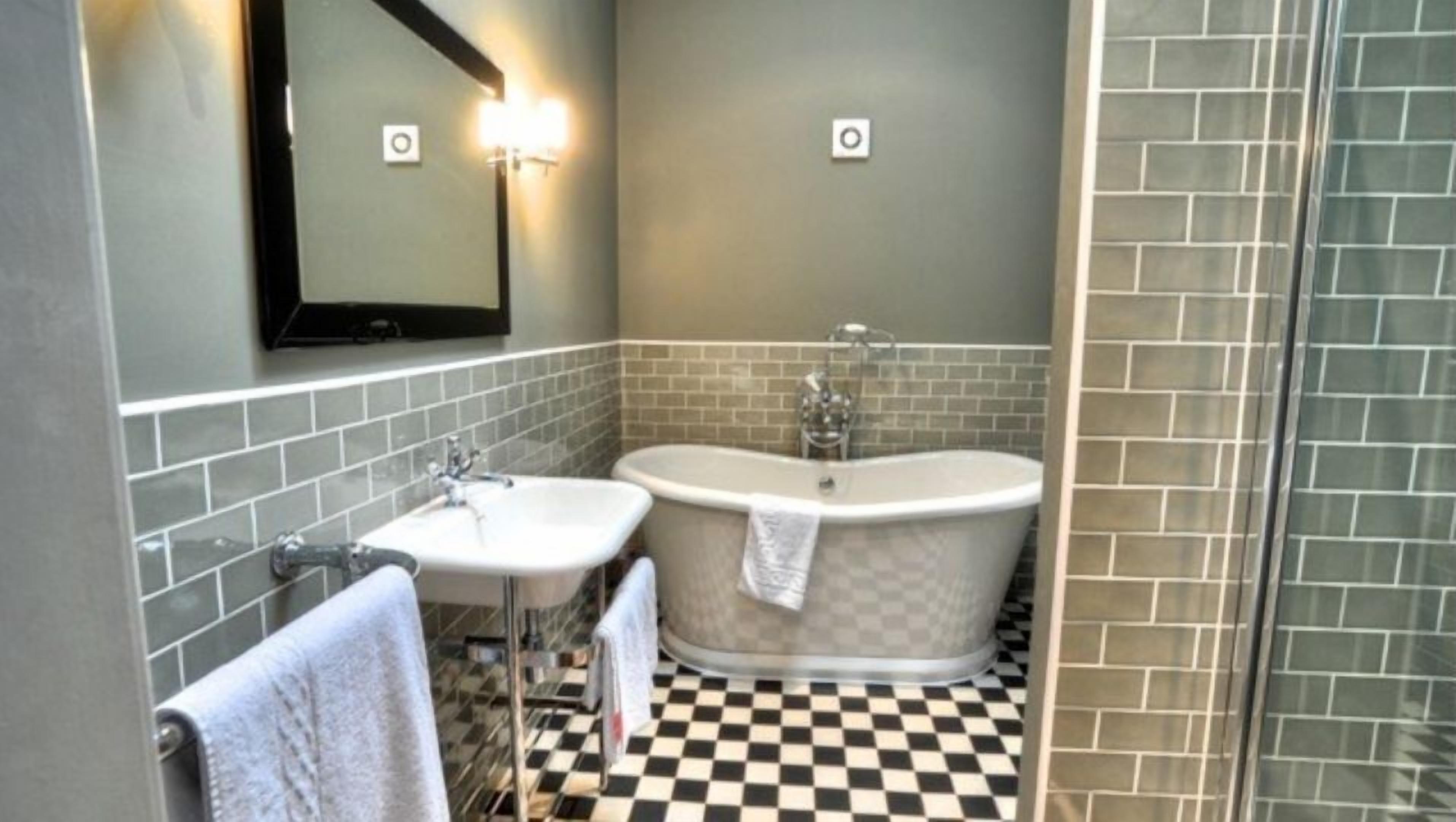 suite with four poster bed | bathroom | combined shower/bathtub, hair dryer, towels