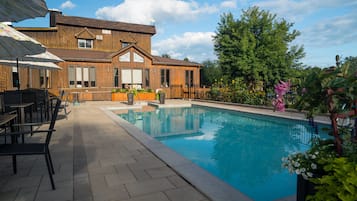 Seasonal outdoor pool, open 8:00 AM to 10:00 PM, pool umbrellas