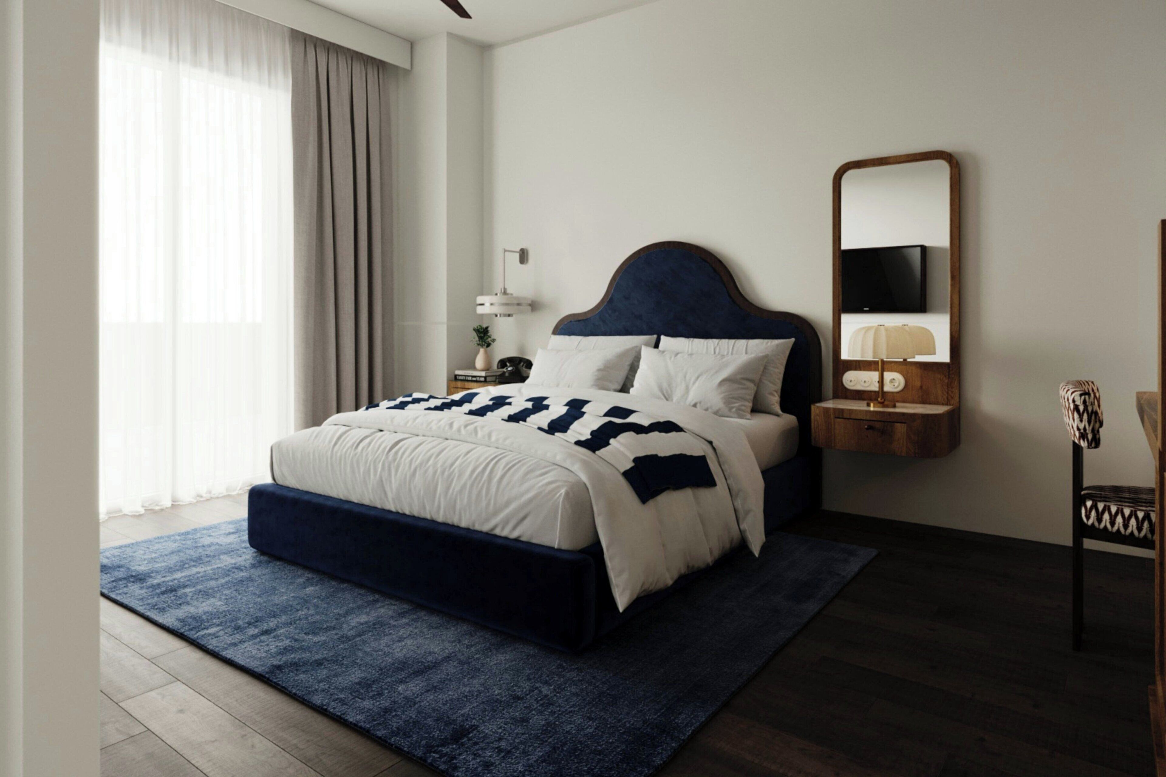 Un dormitorio moderno con cama, mesita de noche, lámpara y espejo.