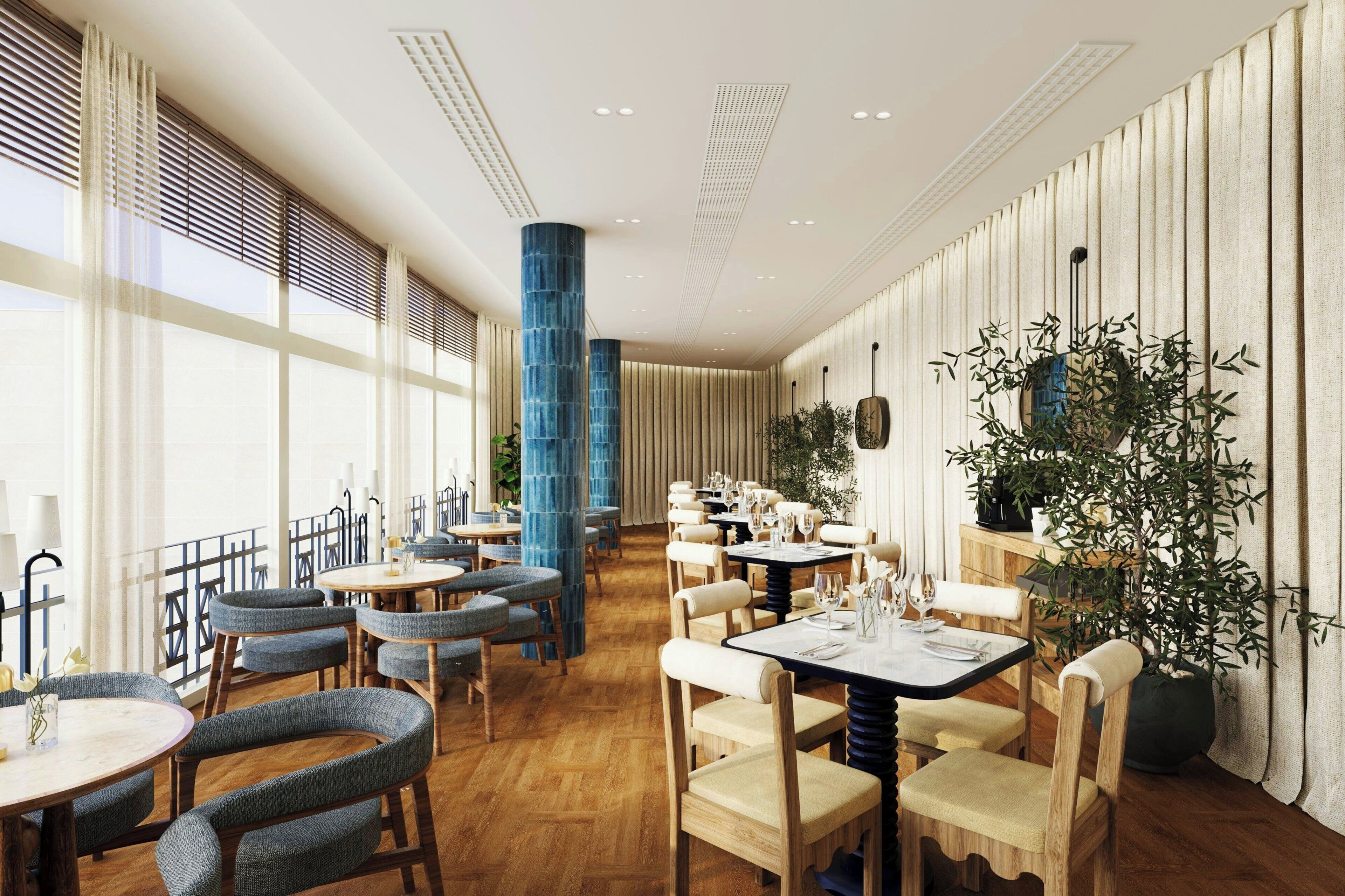 A restaurant with round tables, chairs, and a large potted plant.