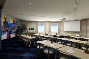 A conference room with multiple tables, chairs, a projector screen, and a large abstract painting on the wall. - Jadran, Rijeka, a Tribute Portfolio Hotel (Rijeka)