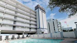 A hotel with multiple balconies, a swimming pool, and a sign reading "Marjac Suites". - Marjac Suites Virginia Beach Oceanfront (Virginia Beach)