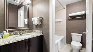 A bathroom with a sink, mirror, towel rack, and toilet.