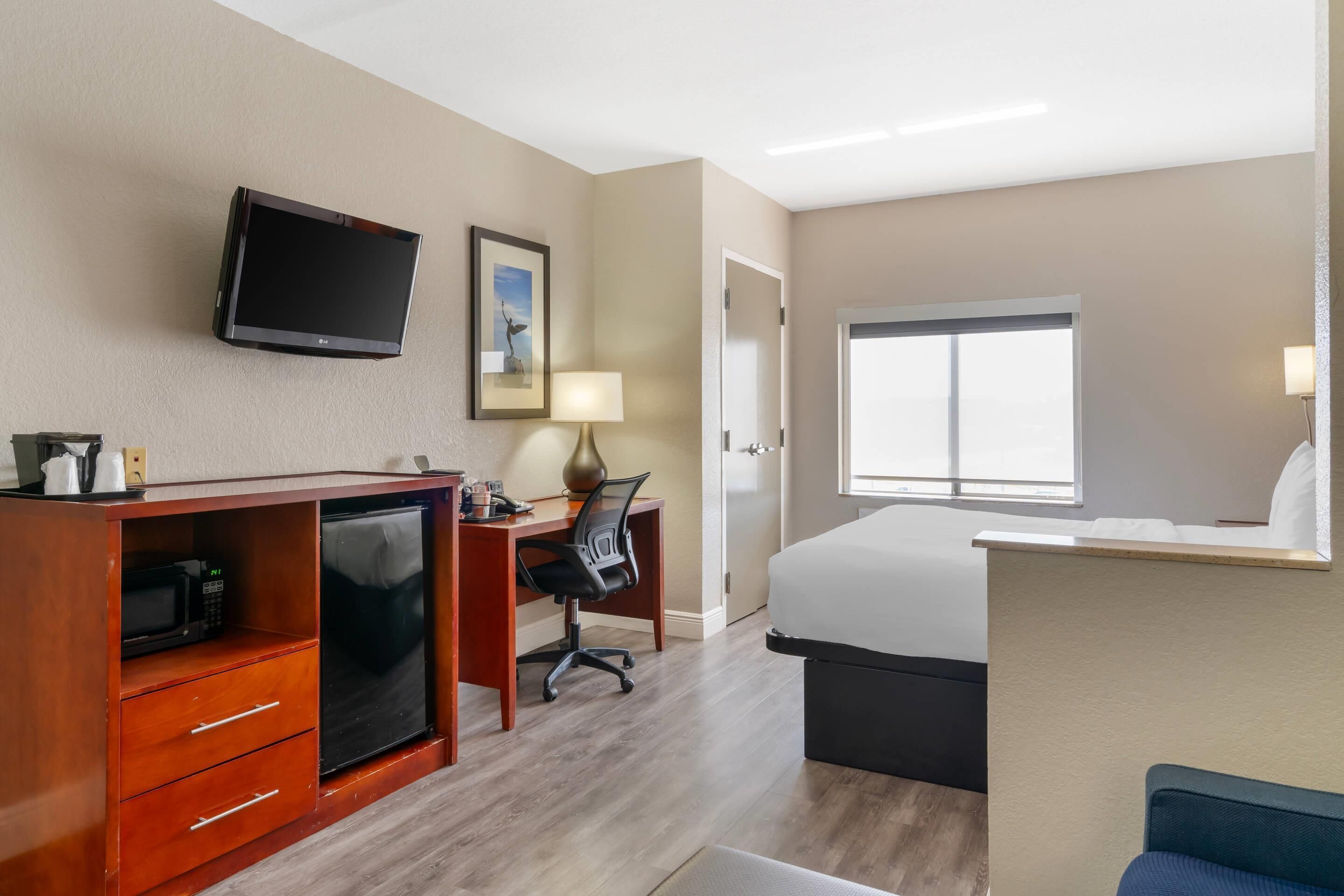 Premium bedding, desk, laptop workspace, blackout drapes