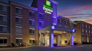 A Holiday Inn Express & Suites building with a prominent sign, multiple entry points, and a covered entrance area. - Holiday Inn Express & Suites Milwaukee Nw Park Place by IHG (Milwaukee)