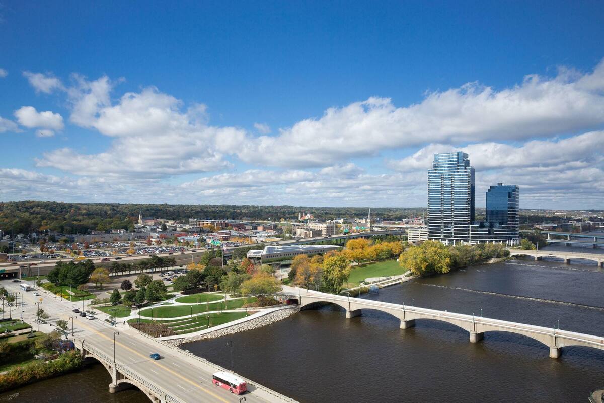 A cityscape with a river, bridges, and modern buildings.