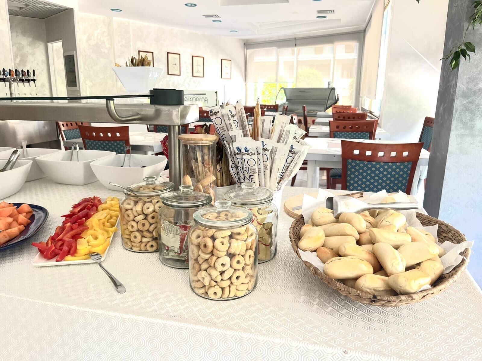 A buffet with various food items including fruits, vegetables, and pastries.