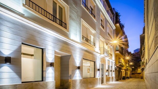 A narrow urban street with buildings featuring balconies and large windows. - Hotel YIT Casablanca (Granada)