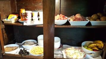 Una mesa buffet de madera con diversos alimentos y salsas.