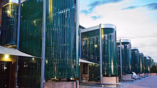 A modern building with curved glass panels and metal structures. - AS Hotel Monza (Monza)