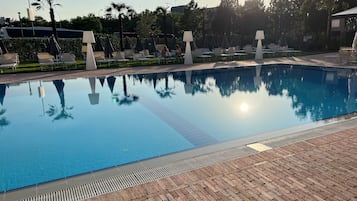 Seasonal outdoor pool, open 9:00 AM to 7:30 PM, pool umbrellas