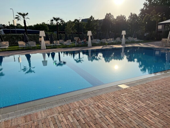 Seasonal outdoor pool, open 9:00 AM to 7:30 PM, pool umbrellas