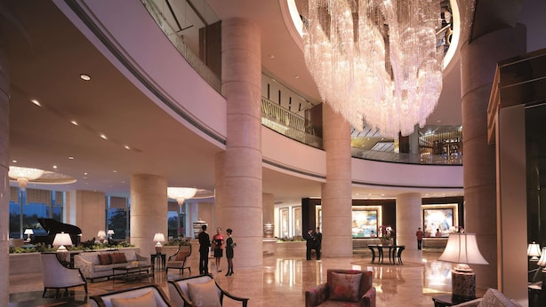 A spacious lobby with high ceilings, large chandeliers, and a grand piano. - Shangri-La Huhhot (Hohhot)