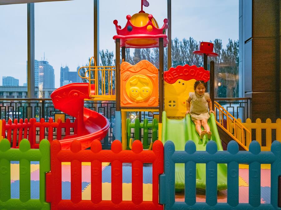 A children's play area with a slide and climbing structures.