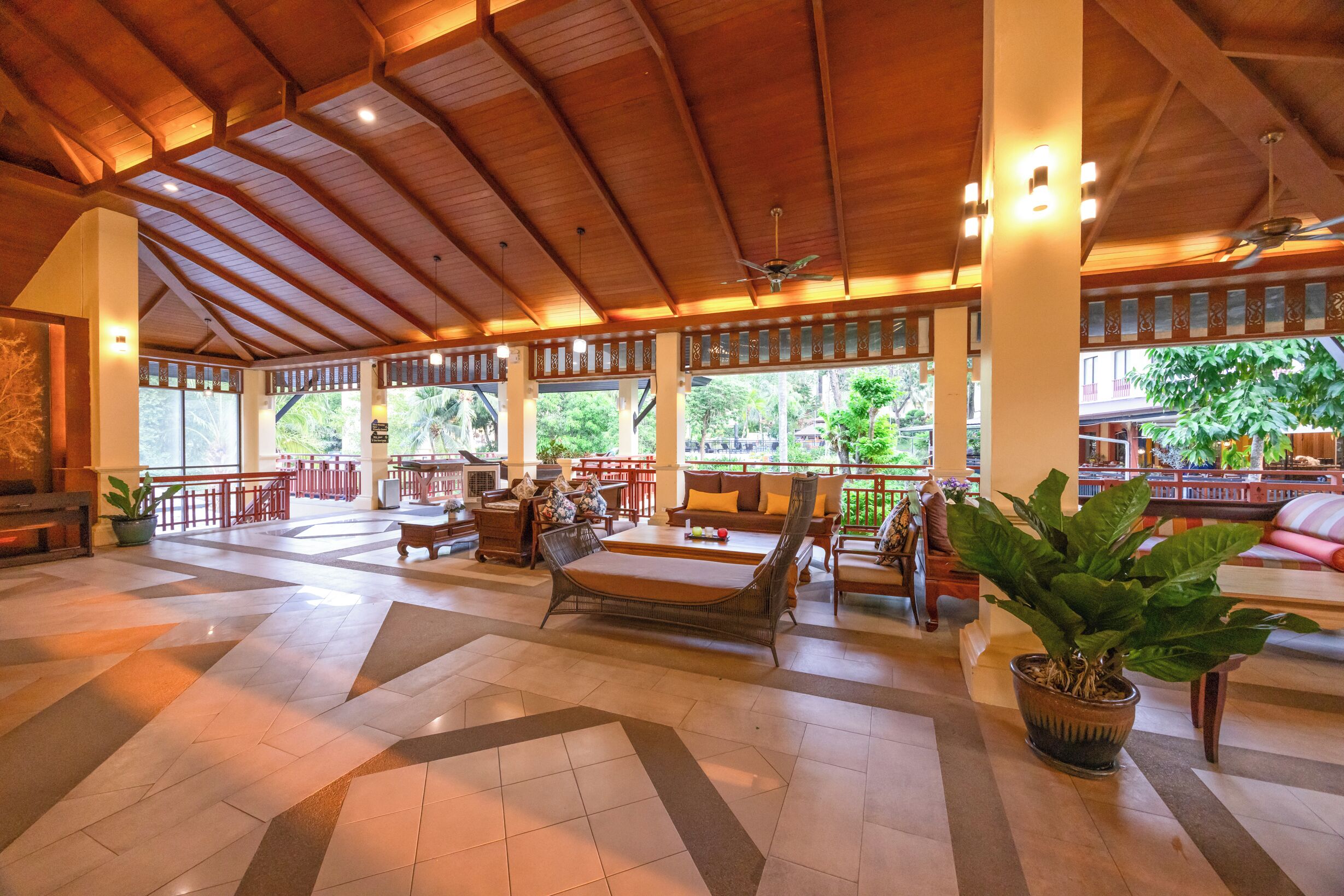 A spacious lobby with a high ceiling, large windows, and a variety of seating arrangements.