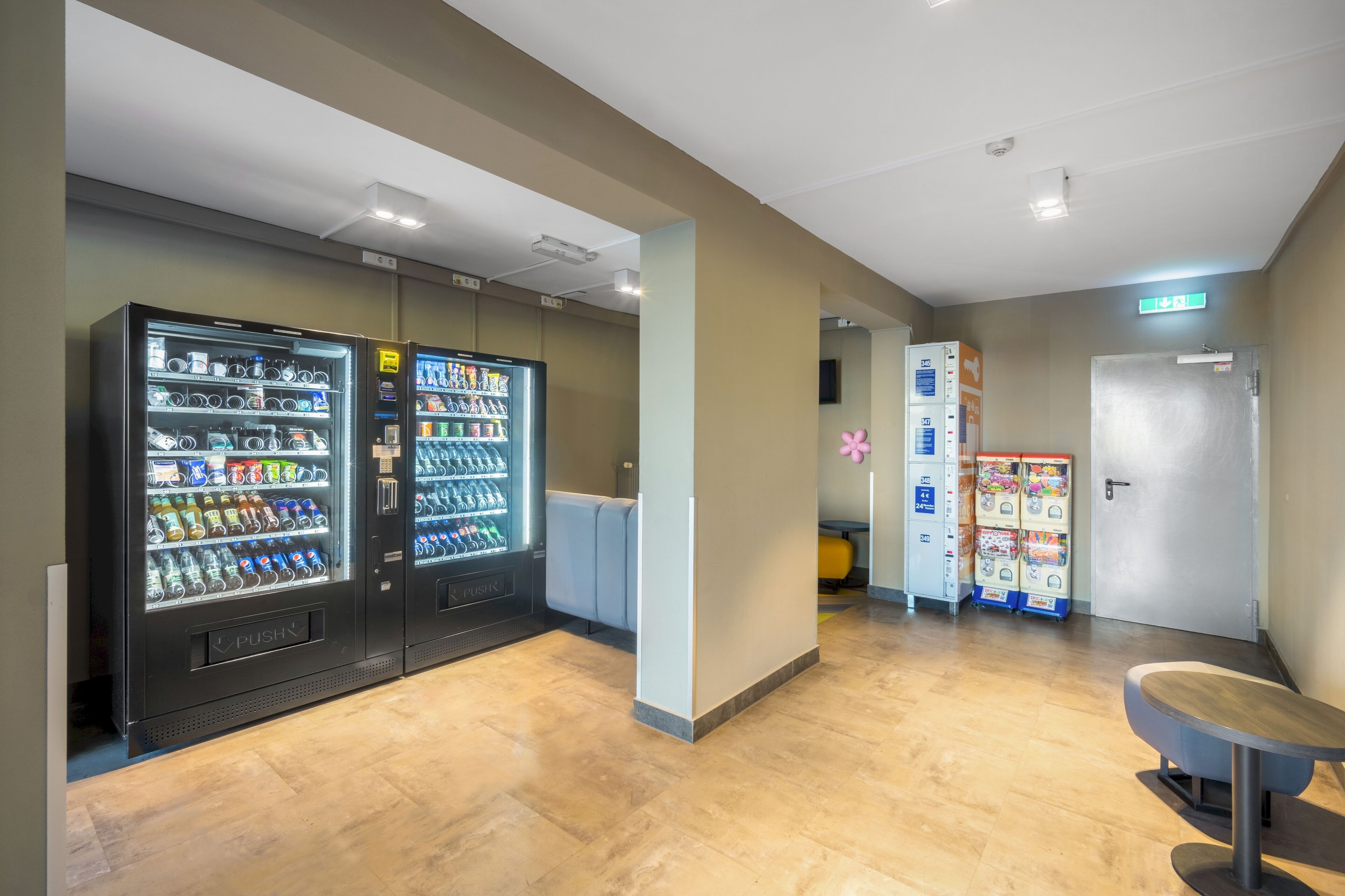 A lobby with vending machines, a reception desk, and a door.
