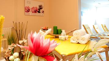 Unwind in a serene spa room with a neatly arranged table, comfortable seating, and a variety of spa products.