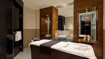 A modern bathroom with a large bathtub, a vanity with a mirror, and a sink.