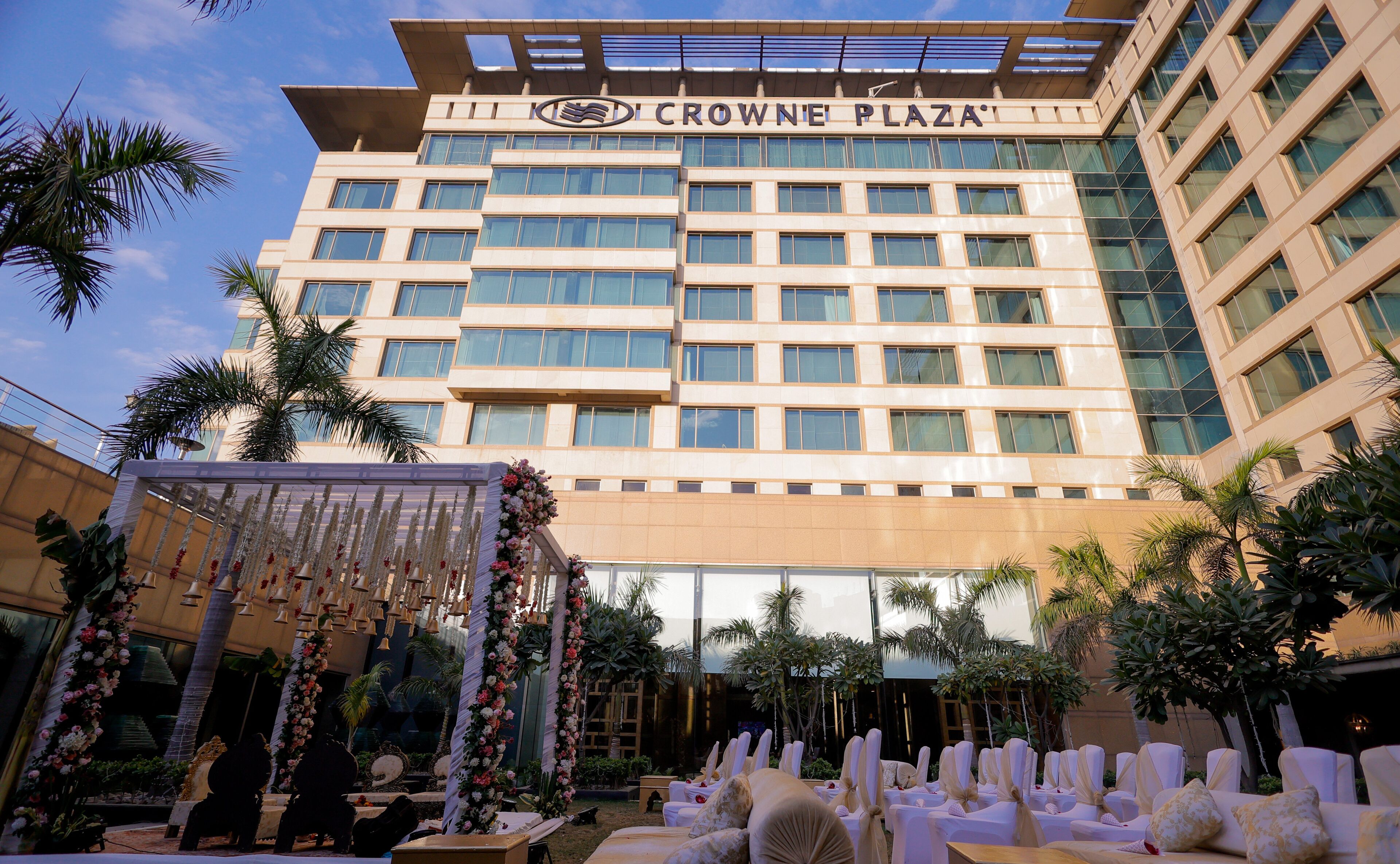 A hotel with a modern facade, multiple floors, and a sign reading "CROWNE PLAZA".