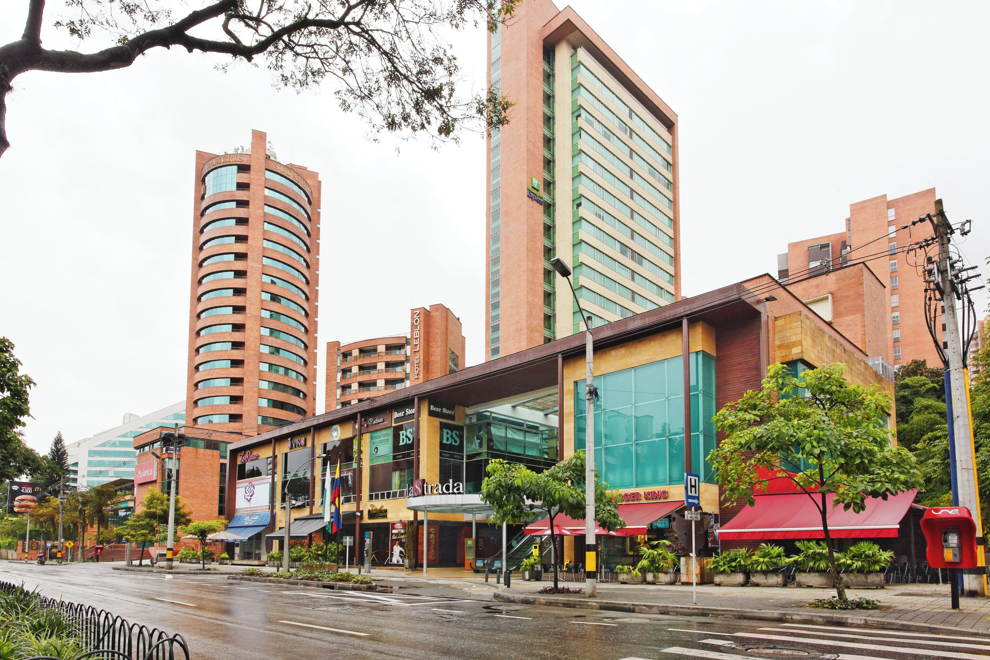 A multi-story hotel with a modern design, featuring a prominent glass facade and a curved structure.