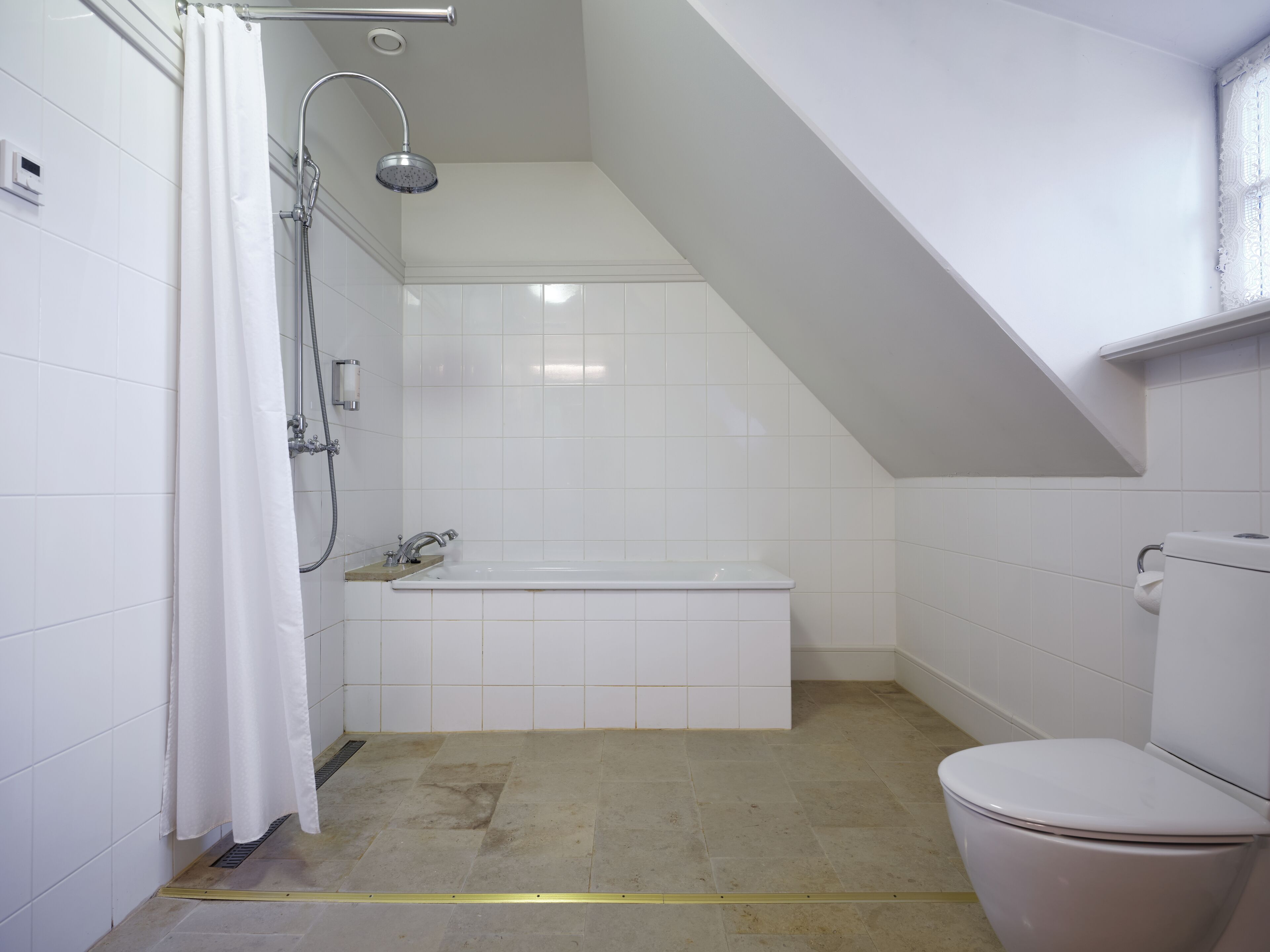 A bathroom with a shower, bathtub, and toilet.